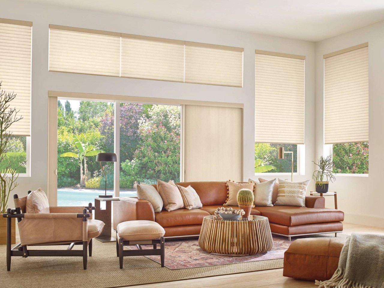 Living room featuring windows decorated with Hunter Douglas Sonnette® Roller Shades near Bellingham, WA