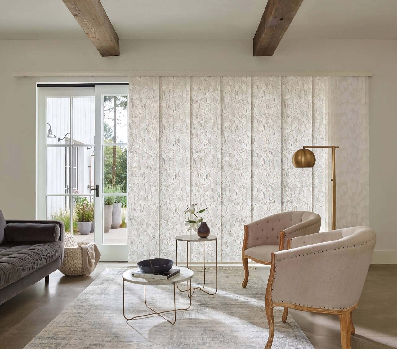 Hunter Douglas Skyline® Panel-Track Blinds on a sliding glass door in a chic, neutral living room at Walls & Windows near Bellingham, WA