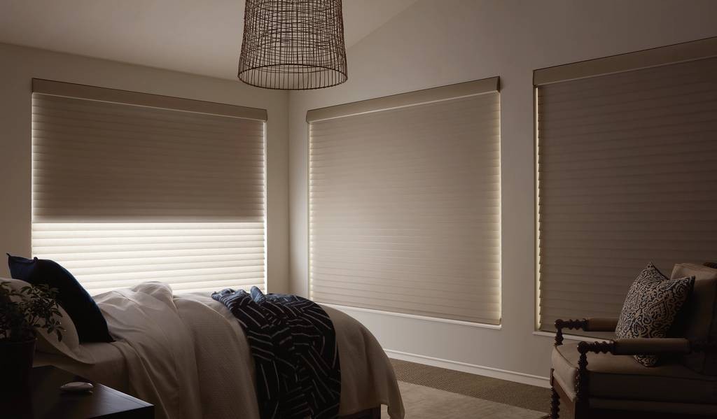 Dark home bedroom with windows covered with window treatments from Hunter Douglas with Hunter Douglas PowerView® Automation at Walls & Windows near Bellingham, WA