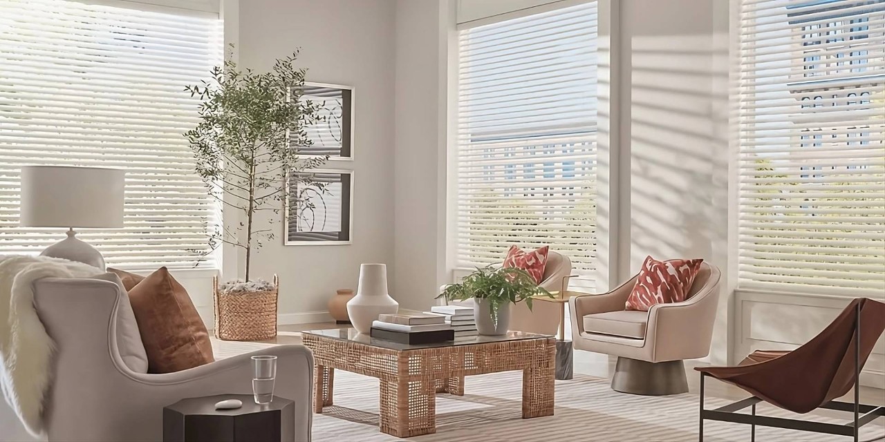 Hunter Douglas Aria™ Fabric Blinds on large windows in a neutrally chic and well-decorated living room at Walls & Windows near Bellingham, WA